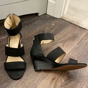 Gently worn, open-toed wedge sandals.